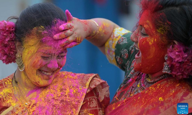 A woman smears colored powder on another woman's face during the celebration to mark Holi, the spring festival of colors, in Agartala, the capital city of India's northeastern state of Tripura, March 24, 2024.(Photo: Xinhua)