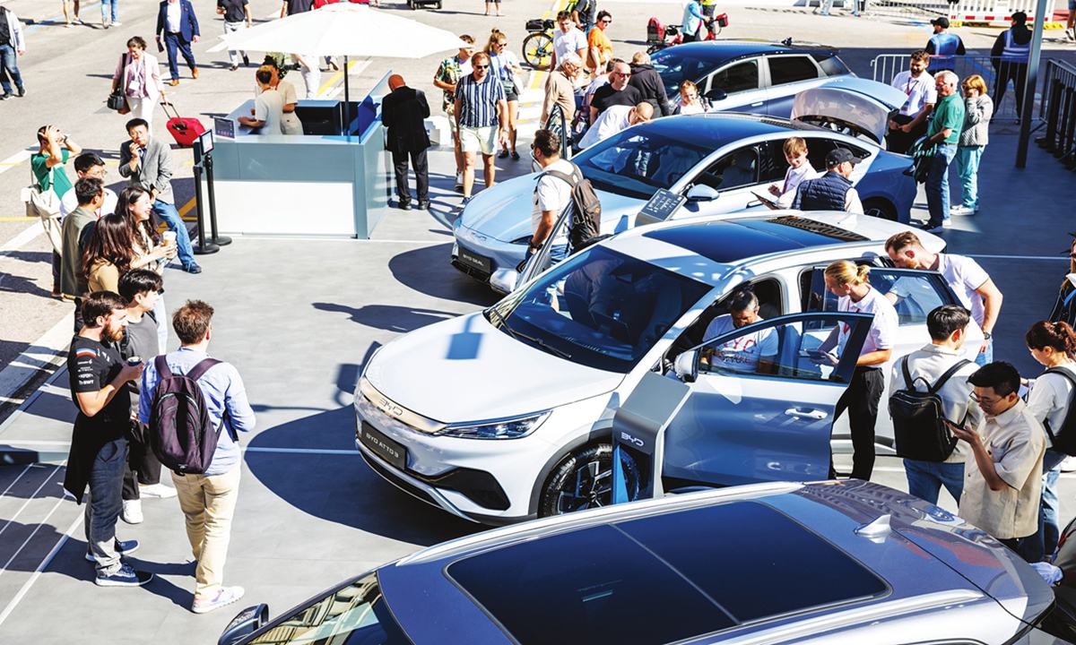 Visitors inspect vehicles at the booth of Chinese manufacturer BYD at the Open Space of the IAA 2023 auto show in Munich, Germany on September 5, 2023. Photo: VCG