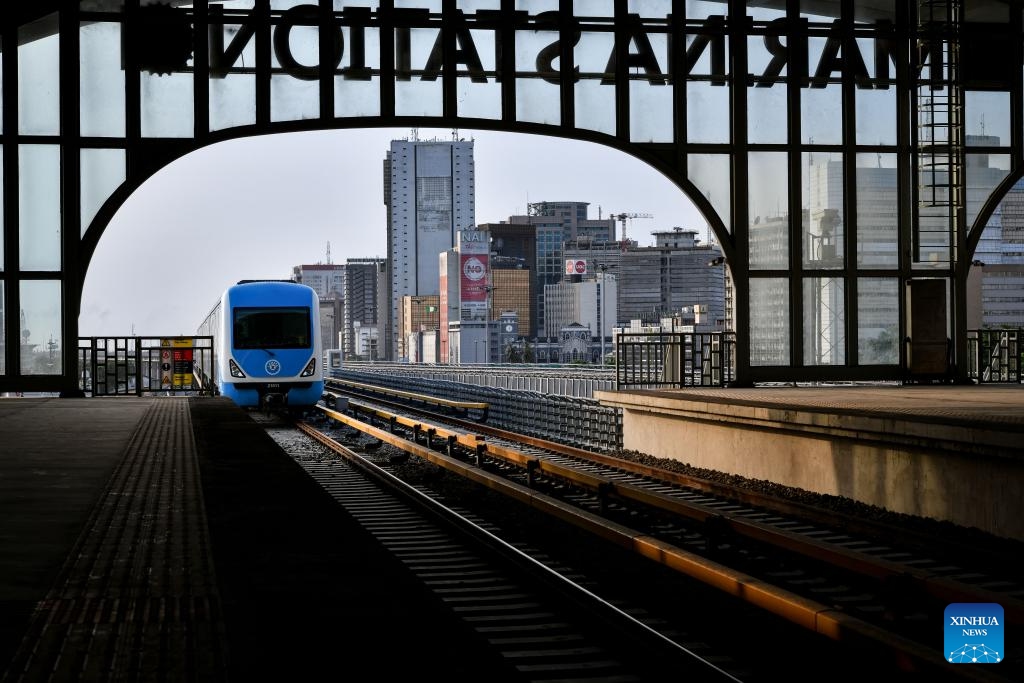 A drone photo taken on March 4, 2024 shows a train of the Lagos Rail Mass Transit (LRMT) Blue Line pulling in the Marina Station in Lagos, Nigeria. Undertaken by China Civil Engineering Construction Corporation (CCECC) in July 2010 and completed in Dec. 2022, the first phase of the Lagos Rail Mass Transit (LRMT) Blue Line corridor spans 13 km and covers five stations. It began commercial operation in Sept. of 2023.(Photo: Xinhua)