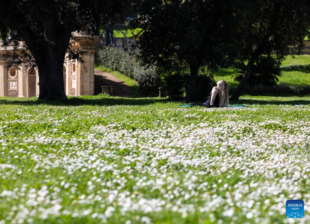 A woman sunbaths at Villa Doria Pamphilj in Rome, Italy, March 21, 2024.(Photo: Xinhua)