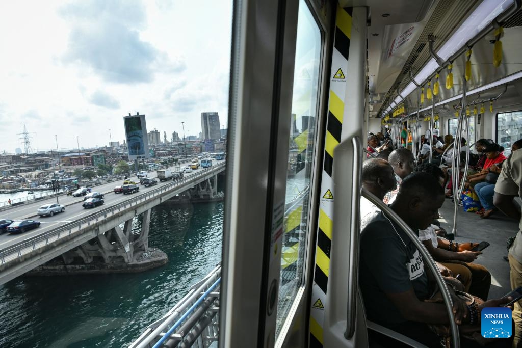 People take a train of the Lagos Rail Mass Transit (LRMT) Blue Line in Lagos, Nigeria, Feb. 28, 2024. Undertaken by China Civil Engineering Construction Corporation (CCECC) in July 2010 and completed in Dec. 2022, the first phase of the Lagos Rail Mass Transit (LRMT) Blue Line corridor spans 13 km and covers five stations. It began commercial operation in Sept. of 2023.(Photo: Xinhua)