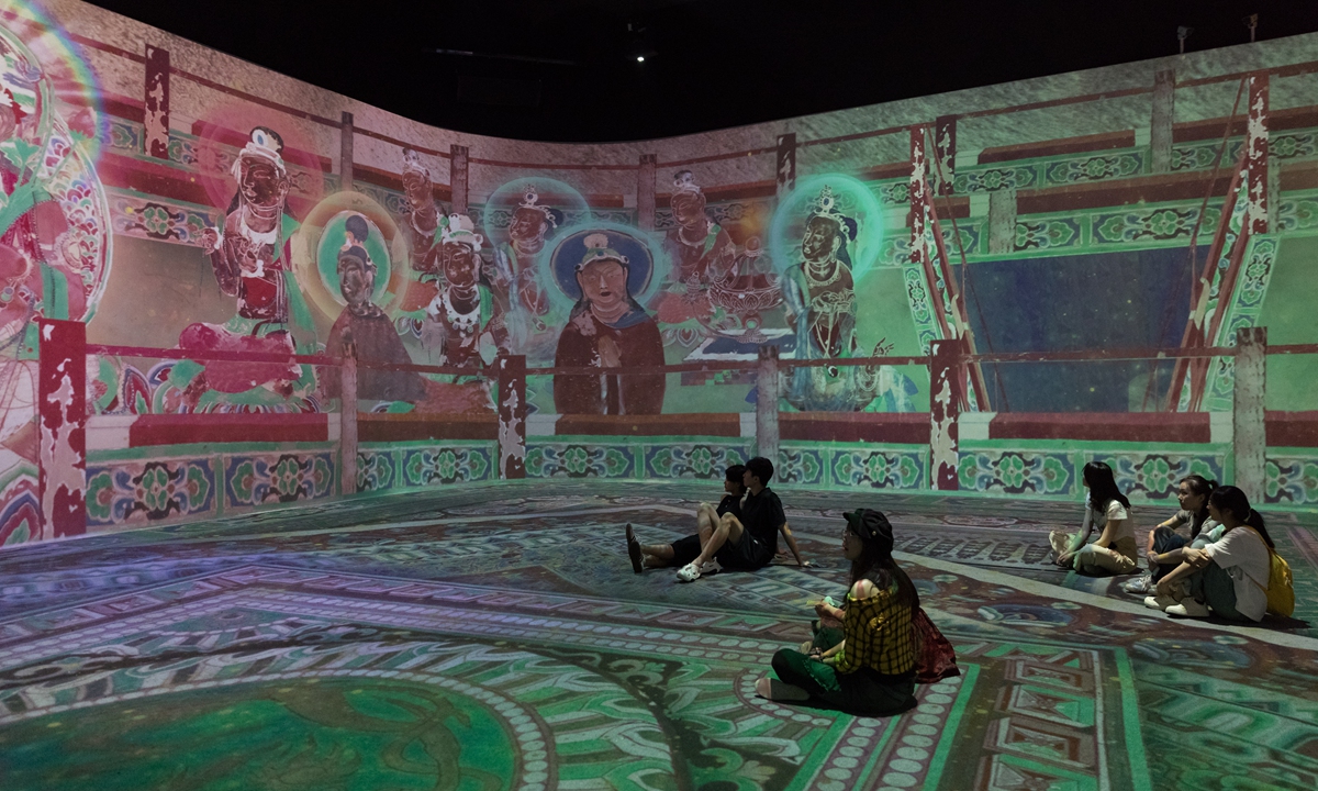 Visitors immerse themselves in a digital exhibition of Dunhuang murals in Hefei, East China’s Anhui Province. Photo: VCG