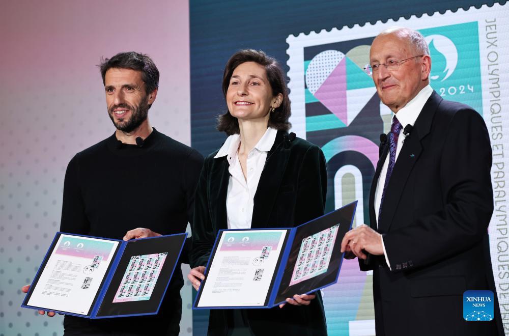 President of the Paris 2024 Organizing Committee Tony Estanguet, French Sports Minister Amelie Oudea-Castera and Chief Executive Officer of La Poste Group Philippe Wahl (L to R) pose with the official stamps for the Paris 2024 Olympic and Paralympic Games during a presentation at the French Postal Museum in Paris, France, March 26, 2024. (Photo: Xinhua)
