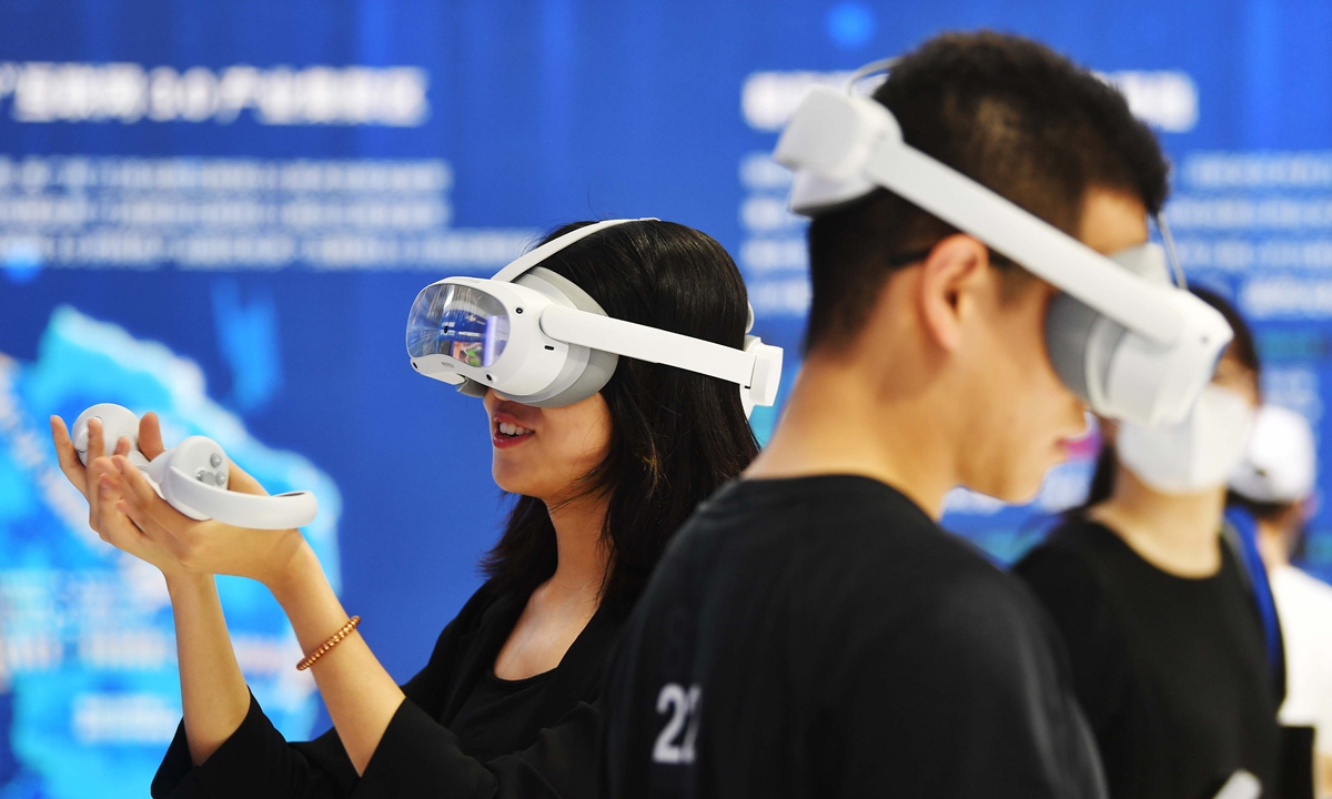 People wear smart glasses to experience the virtual world at the 2023 Global Digital Economy Conference in Beijing, on July 4, 2023. Photo: VCG 