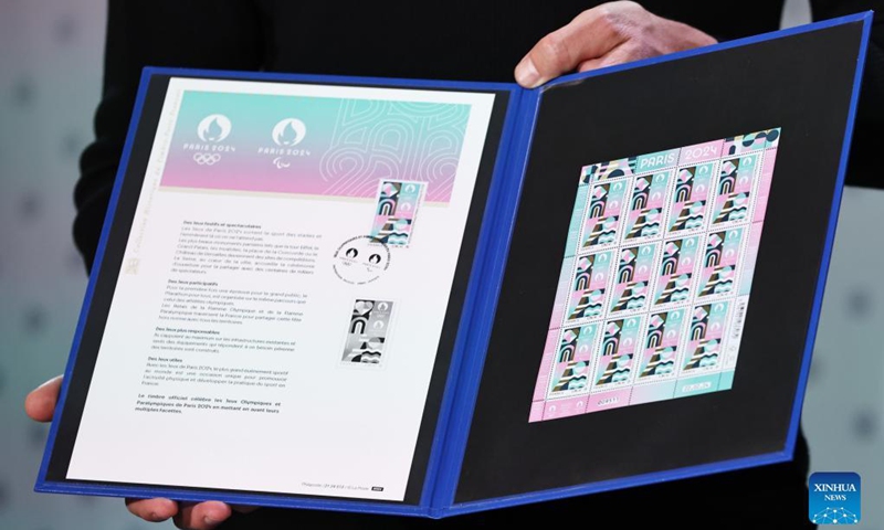 The official stamps for the Paris 2024 Olympic and Paralympic Games are seen during a presentation at the French Postal Museum in Paris, France, March 26, 2024. Drawing inspiration from the visual identity of the Paris Olympics, the stamp highlights iconic places like the Eiffel Tower and the River Seine, with sporting elements of athletics tracks and ball bounces featured in it. The stamp has exceptional finishes with hot stamping.(Photo: Xinhua)