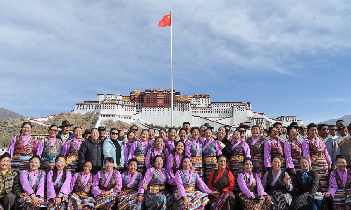 People pose for photos after a flag-raising ceremony to celebrate the Serfs' Emancipation Day at the square in front of the Potala Palace in Lhasa, capital of Southwest China's Xizang Autonomous Region, March 28, 2024. Photo: cnsphoto