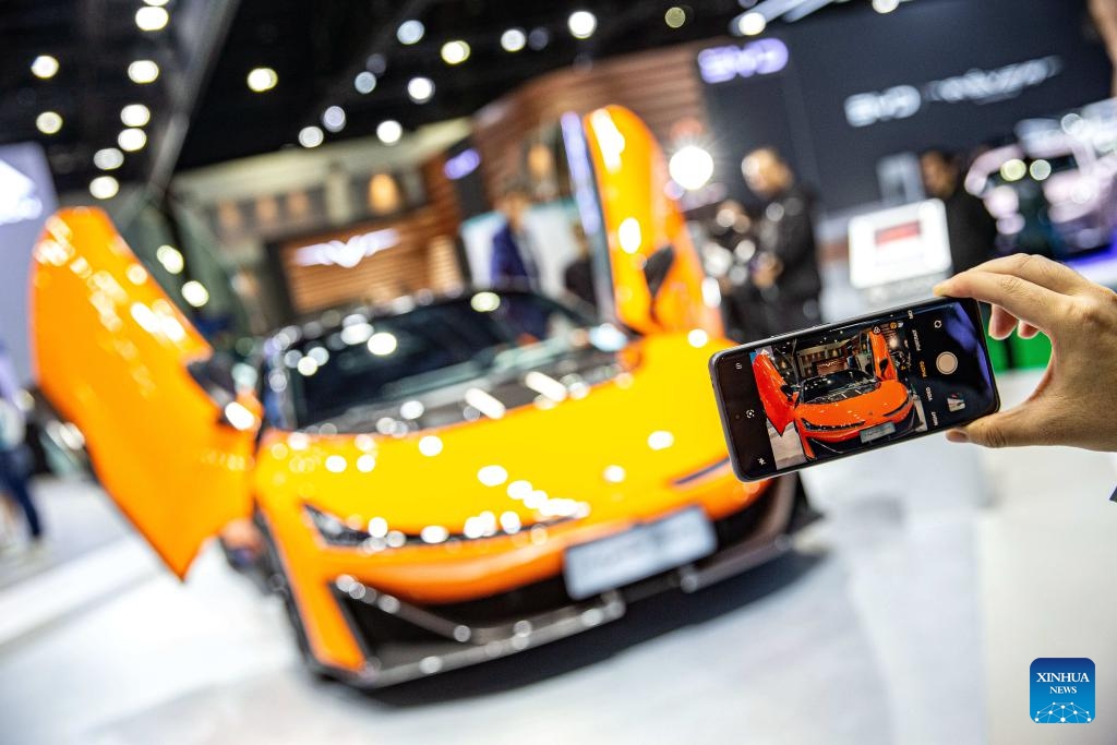 A visitor takes photos of a Hyper SSR at the booth of GAC Aion during the 45th Bangkok International Motor Show in Bangkok, Thailand, March 27, 2024. The 45th Bangkok International Motor Show kicked off here on Wednesday and will last until April 7.(Photo: Xinhua)