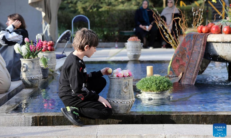 A boy watches colourful eggs displayed for the Nowruz, the Iranian New Year, outside the Niavaran Palace in northern Tehran, capital of Iran, March 26, 2024. People visited the Niavaran Palace during the new year vacation of Nowruz, which falls on March 20 this year.(Photo: Xinhua)