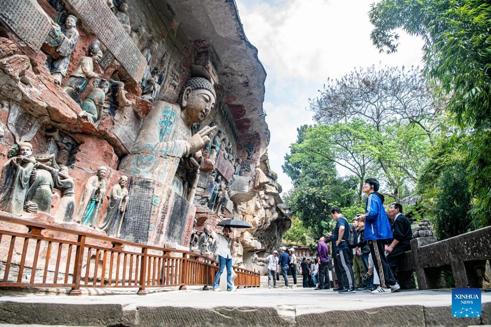 Tourists visit the scenic spot of Dazu Rock Carvings in southwest China's Chongqing, March 27, 2024. The Dazu Rock Carvings were placed on the World Heritage List by the United Nations Educational, Scientific and Cultural Organization (UNESCO) in 1999. (Photo: Xinhua)