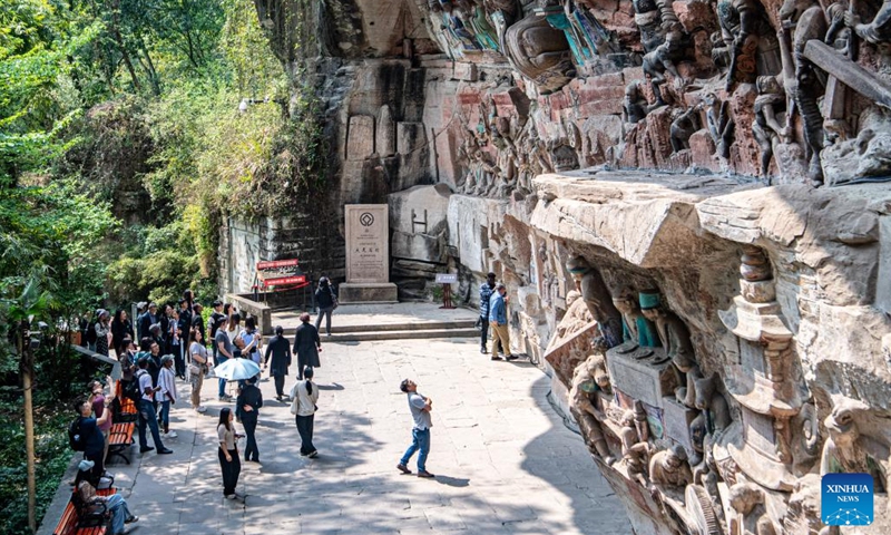 Tourists visit the scenic spot of Dazu Rock Carvings in southwest China's Chongqing, March 27, 2024. The Dazu Rock Carvings were placed on the World Heritage List by the United Nations Educational, Scientific and Cultural Organization (UNESCO) in 1999. (Photo: Xinhua)