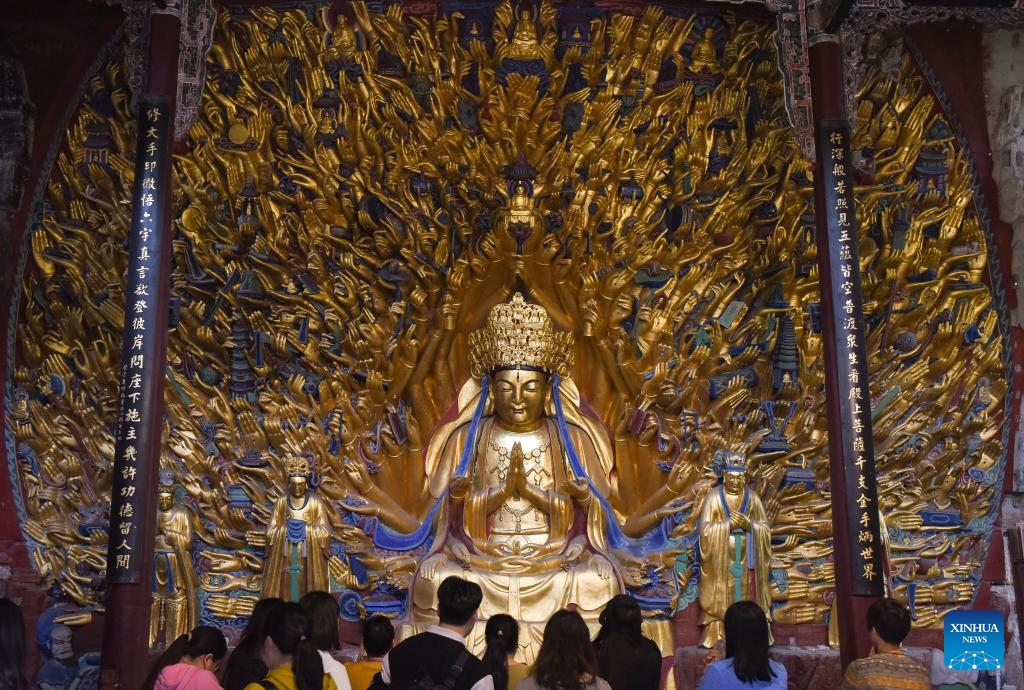 Tourists visit the scenic spot of Dazu Rock Carvings in southwest China's Chongqing, March 27, 2024. The Dazu Rock Carvings were placed on the World Heritage List by the United Nations Educational, Scientific and Cultural Organization (UNESCO) in 1999. (Photo: Xinhua)