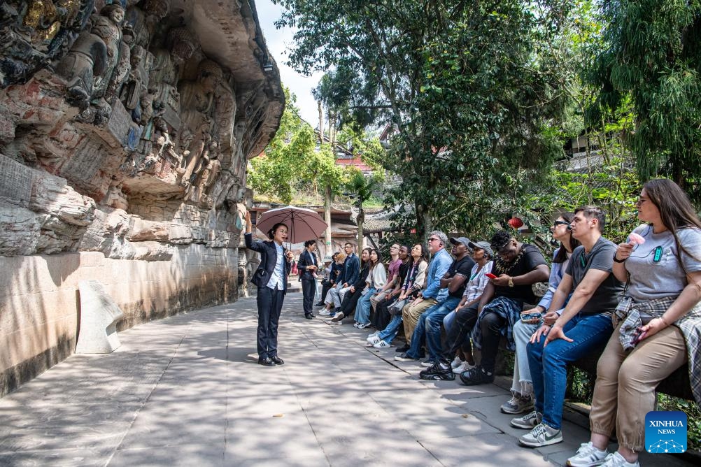Tourists visit the scenic spot of Dazu Rock Carvings in southwest China's Chongqing, March 27, 2024. The Dazu Rock Carvings were placed on the World Heritage List by the United Nations Educational, Scientific and Cultural Organization (UNESCO) in 1999. (Photo: Xinhua)
