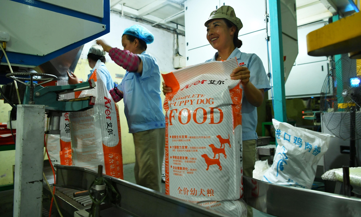 Various brands of pet food are displayed at a pet supplies exhibition in Beijing on March 1, 2024. Photo: VCG