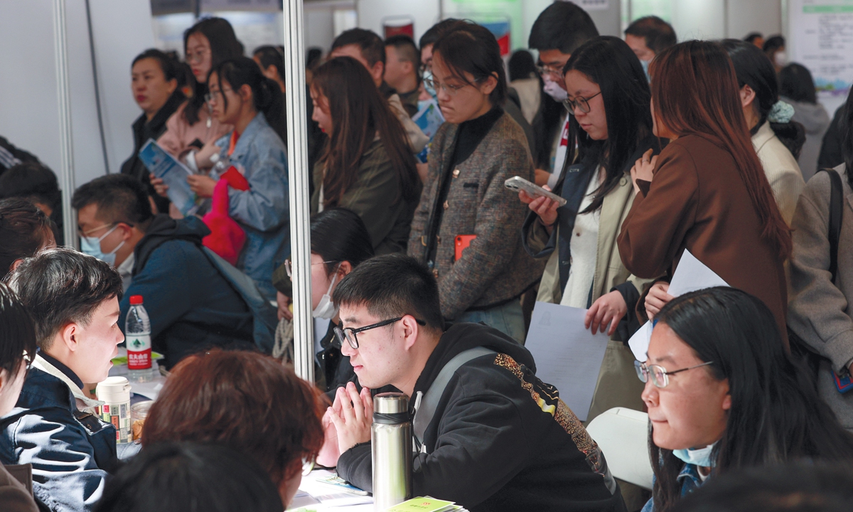 People hunt for jobs at the 2024 Beijing large-scale spring on-site job fair on March 30, 2024. The recruitment event brought together 200 enterprises and institutions providing nearly 7,000 job opportunities. Photo: IC