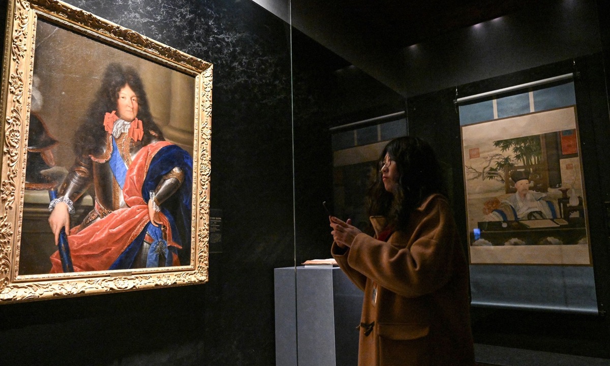 A visitor explores the <em>Forbidden City and the Palace of Versailles: Exchanges Between China and France in the 17th and 18th Centuries</em> exhibition at the Palace Museum on April 1, 2024. Photo: VCG