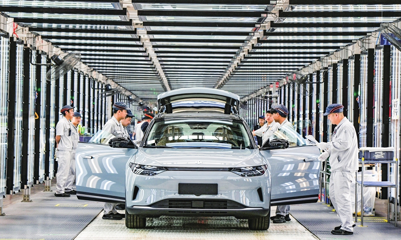 Workers complete assembling an electric vehicle (EV) at China's EV start-up Leapmotor in Jinhua, East China's Zhejiang Province on April 1, 2024. The smart EV factory delivered 14,567 new vehicles in March, a yearly increase of 136 percent. Photo: VCG