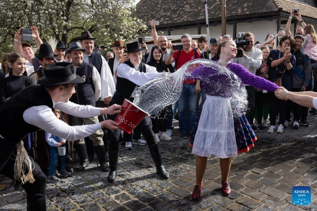 A man splashes water onto a woman as part of the traditional Easter celebration in Holloko, Hungary, on April 1, 2024.(Photo: Xinhua)
