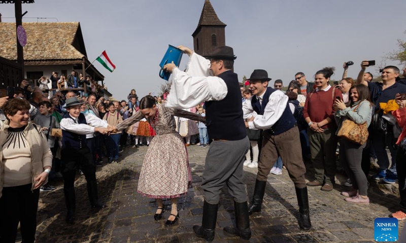 A man splashes water onto a woman as part of the traditional Easter celebration in Holloko, Hungary, on April 1, 2024.(Photo: Xinhua)