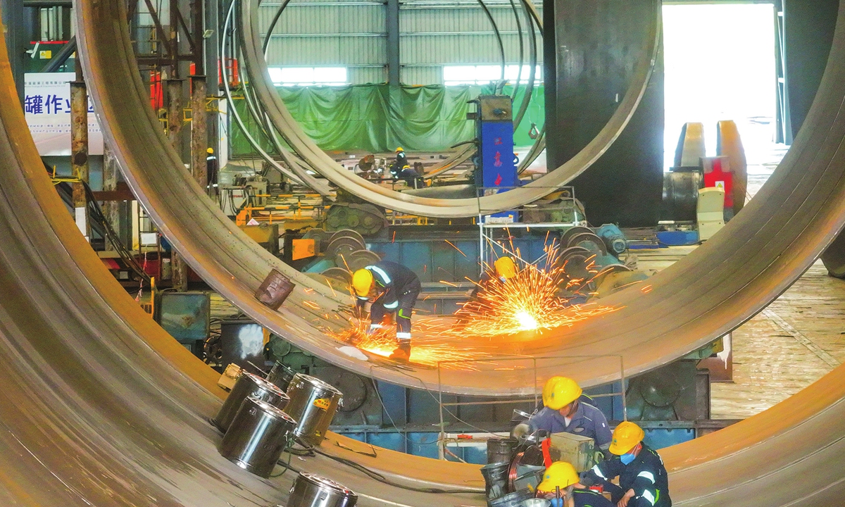Workers are busy making the monopiles for offshore wind power plants in an industrial park in Qidong, East China's Jiangsu Province on April 2, 2024. The amount of newly approved offshore wind power in China in January reached 5.12GW, equivalent to 55 percent of the total in 2022, industry data showed. Photo: cnsphoto