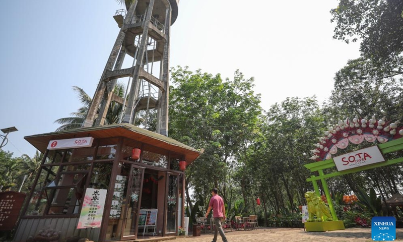 A tourist visits a water tower coffee house in Dashan Village of Longmen Township, Ding'an County, south China's Hainan Province, April 4, 2024. In recent years, Longmen Township in Ding'an County of Hainan has been developing its coffee tourism industry to attract tourists and promote its development. (Xinhua/Zhang Liyun)