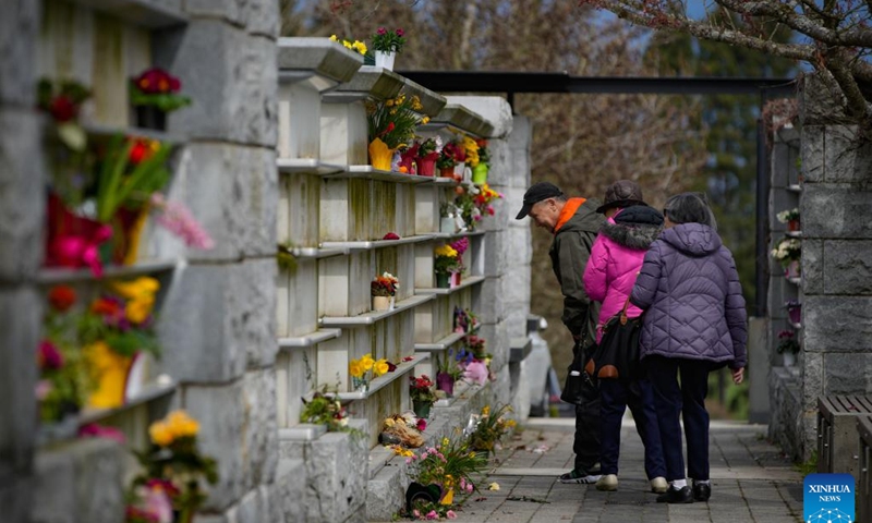 People pay tributes to the deceased on Qingming Festival, or Tomb-Sweeping Day, at the Mountain View Cemetery in Vancouver, British Columbia, Canada, April 4, 2024. (Photo by Liang Sen/Xinhua)