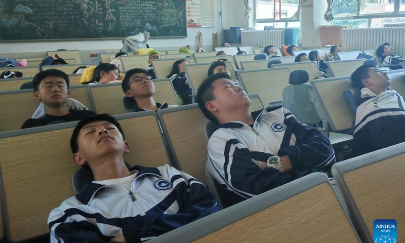 This photo taken with a mobile phone shows students taking noon naps at a classroom of a middle school in Liupanshui City, southwest China's Guizhou Province, April 2, 2024. (Xinhua/Zheng Minghong)