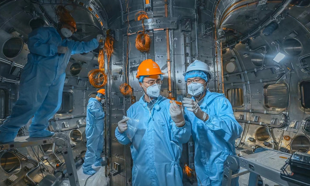 Technicians debug components within the vacuum chamber of HL-3 at the Southwestern Institute of Physics (SWIP). Photo: Courtesy of SWIP