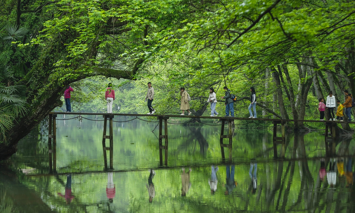 Tourists stroll through the Xixinan wetlands in the Huizhou district of Huangshan, East China's Anhui Province, on April 7, 2024. Often described as a 