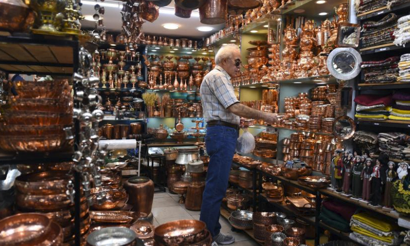 A customer selects goods ahead of Eid al-Fitr at a bazzar in Tehran, Iran, April 7, 2024. (Xinhua/Shadati)