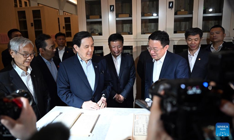 Ma Ying-jeou, former chairman of the Chinese Kuomintang party, looks through collections of the archives at the Xi'an branch of the China National Archives of Publications and Culture in Xi'an, northwest China's Shaanxi Province, April 6, 2024. Ma and a Taiwan youth delegation visited the Xi'an branch of the China National Archives of Publications and Culture on Saturday. (Xinhua/Chen Yehua)