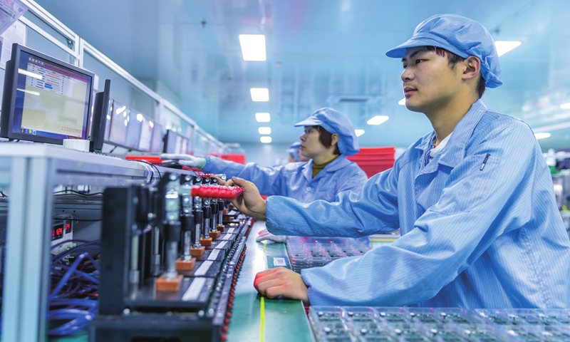 Workers make printed circuit board assembly, the finished product after all the components have been soldered and installed on a printed circuit board (PCB), for mobile phones and new-energy vehicles on April 7, 2024 in Jiujiang, East China's Jiangxi Province. The PCB output value in the Chinese mainland is expected to reach $54.61 billion in 2026.Photo:VCG
