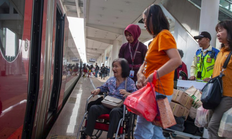 Passengers board a high-speed electrical multiple unit (EMU) train at the Jakarta-Bandung High-Speed Railway's Padalarang Station in Padalarang, Indonesia, April 7, 2024. The holy month of Ramadan and the celebration of Islamic post-fasting festivity Eid-al-Fitr have been associated with a homecoming tradition, locally known as mudik, for many people in Indonesia with the world's largest Muslim population. (Photo by Septianjar Muharam/Xinhua)