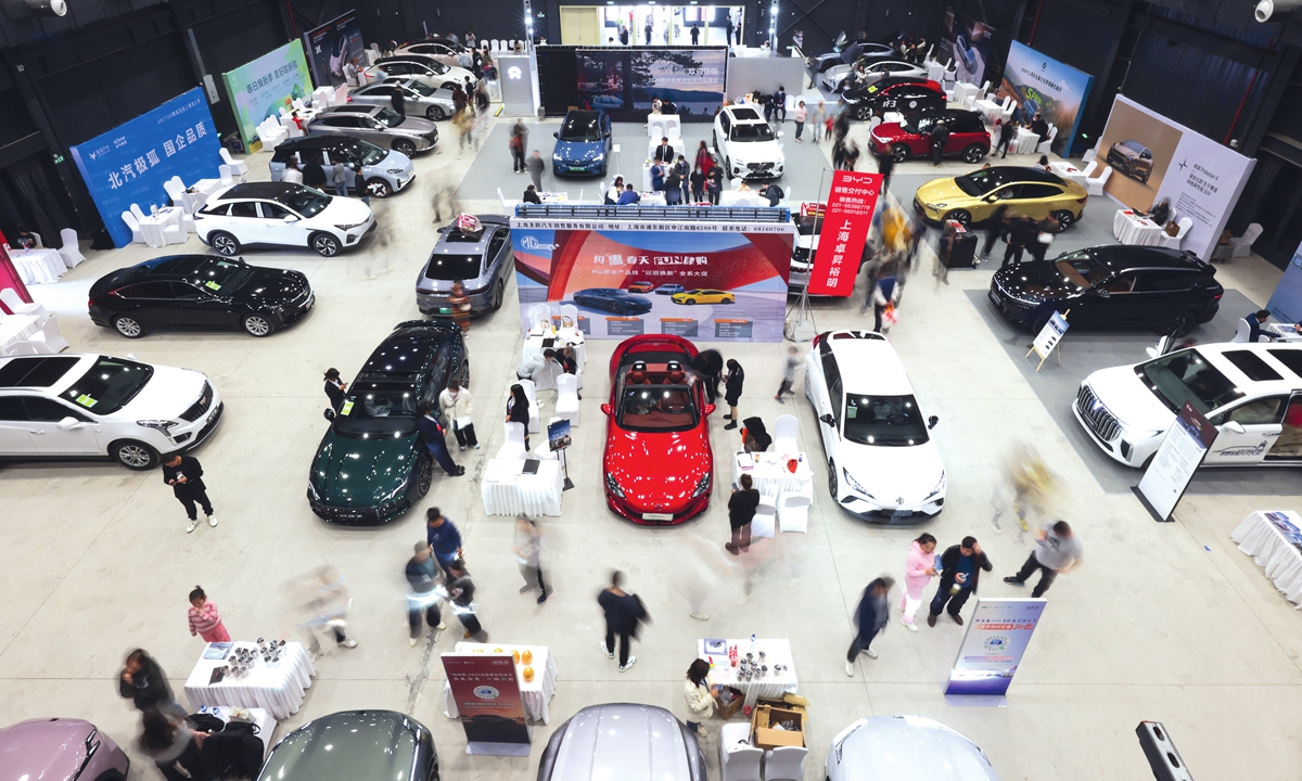 Consumers browse NEVs at a car fair in Shanghai on March 23, 2024. Photo: VCG