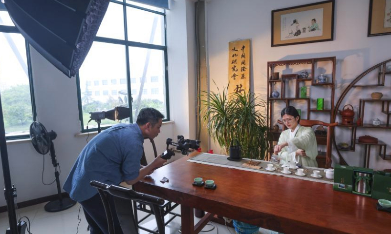 A staff member demonstrates the brew methods of Wuzhou Juyan tea via live streaming in Jinhua, east China's Zhejiang Province, April 7, 2024.