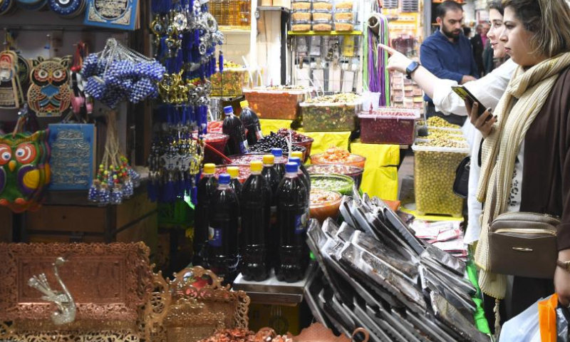 People buy goods ahead of Eid al-Fitr at a bazzar in Tehran, Iran, April 7, 2024. (Xinhua/Shadati)