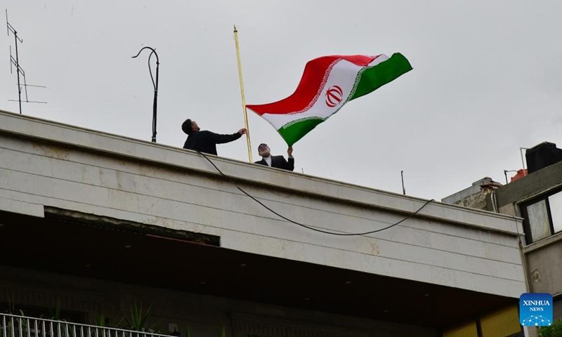 The Iranian flag is raised over the new consulate in Damascus, Syria, on April 8, 2024. Iranian Foreign Minister Hossein Amir-Abdollahian opened a new consulate building in the Syrian capital of Damascus on Monday, following the destruction of the previous consulate by an Israeli strike last week.(Photo: Xinhua)