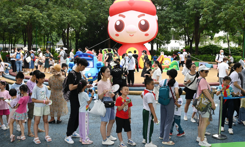 Families with children queue up, eagerly awaiting to participate in interactive games in Guangzhou, Guangdong Province on June 1, 2023. Photo: VCG