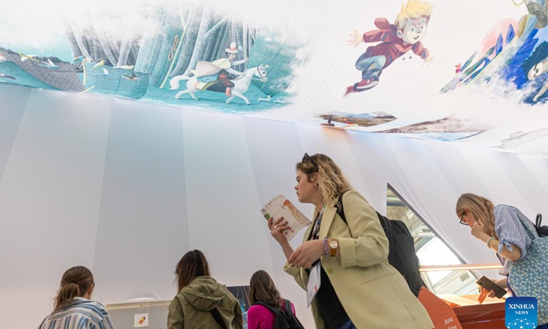 People visit the Bologna Children's Book Fair at Bologna Fiere Center, in Bologna, Italy, April 8, 2024. The 61st Bologna Children's Book Fair kicked off on Monday with the participation of 1,500 exhibitors from about 100 countries and regions of the world. The fair will last until April 11.(Photo: Xinhua)