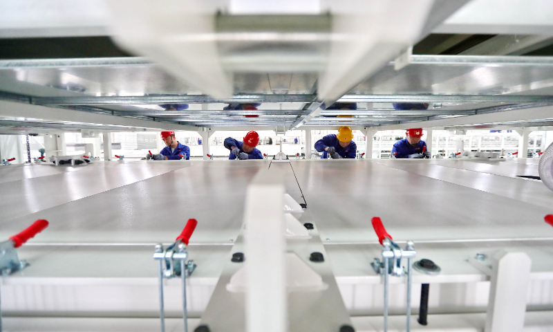 Workers make solar panel laminating machines at a factory in Qinhuangdao, North China's Hebei Province, on April 10, 2024. A manufacturing center for photovoltaic smart equipment went into operation in January, with an annual capacity of 800 solar panel laminators, which are used to produce solar battery modules. Photo: VCG