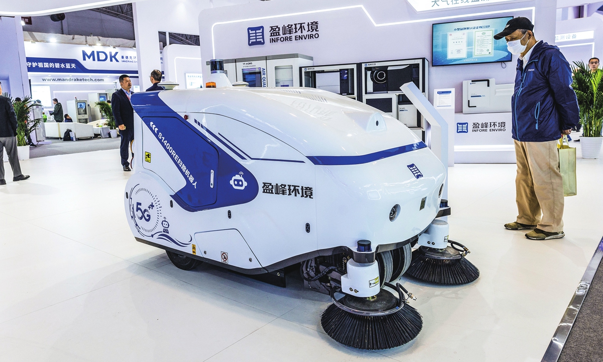A visitor watches a robot sweep at the 22nd China International Environmental Protection Exhibition and Conference, which opened in Beijing on April 10, 2024. The exhibition is expected to attract more than 1,000 domestic and foreign companies, with an anticipated attendance of more than 150,000 people. Photo: Li Hao/GT