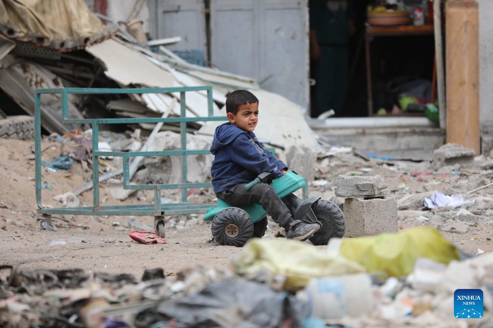 A boy rides a tricycle on a street in Gaza City, April 8, 2024.(Photo: Xinhua)