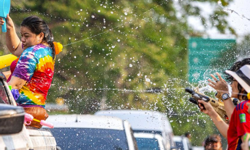 People splash water on one another in celebration of the Songkran festival in Ayutthaya, Thailand, April 13, 2024. The Songkran festival, the traditional Thai New Year, is celebrated from April 13 to 15 every year, during which people express greetings by splashing water on each other. (Xinhua/Wang Teng)