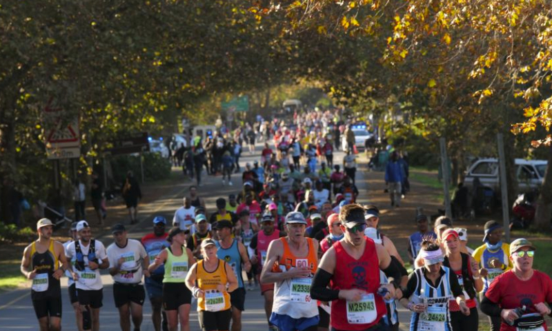 Participants run during the 2024 Two Oceans Marathon in Cape Town, South Africa, April 13, 2024. The Two Oceans Marathon, which is run against a backdrop of spectacular scenery through the Cape Peninsula, has earned a reputation as the world's most beautiful marathon. (Photo by Ian Landsberg/Xinhua)