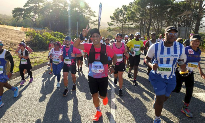 Participants run during the 2024 Two Oceans Marathon in Cape Town, South Africa, April 13, 2024. The Two Oceans Marathon, which is run against a backdrop of spectacular scenery through the Cape Peninsula, has earned a reputation as the world's most beautiful marathon. (Photo by Ian Landsberg/Xinhua)