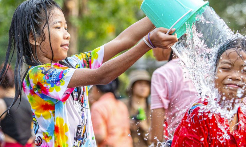 A child splashes water on another child in celebration of the Songkran festival in Ayutthaya, Thailand, April 13, 2024. The Songkran festival, the traditional Thai New Year, is celebrated from April 13 to 15 every year, during which people express greetings by splashing water on each other. (Xinhua/Wang Teng)