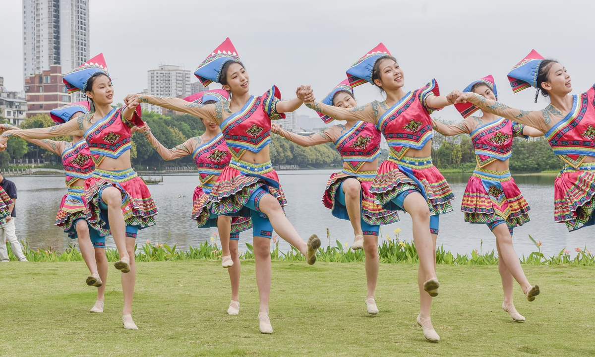 Young men and women in distinctive ethnic costumes celebrate the March 3 Festival with songs and dances by the South Lake in Nanning on April 9, 2024. Photo: VCG