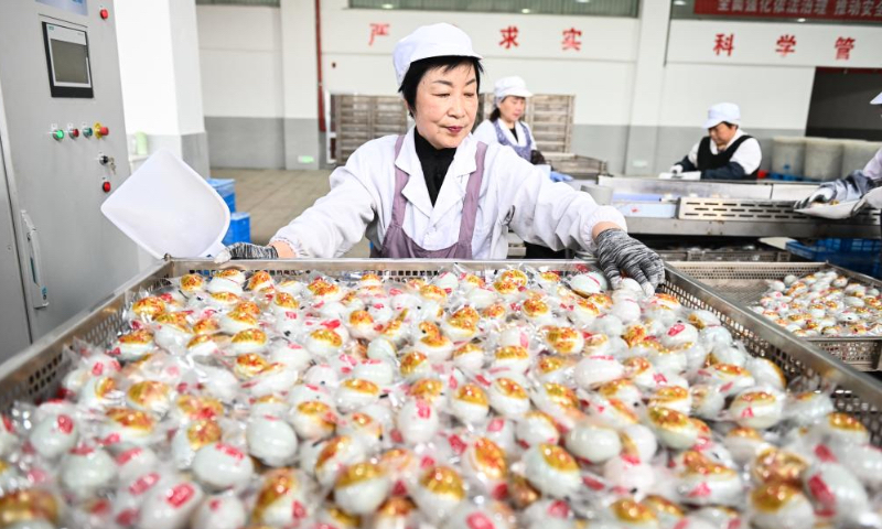Workers are busy at the production line of salted duck eggs in the production workshop of the Jiangsu Gaoyou Duck Co., Ltd. in Gaoyou City, east China's Jiangsu Province, April 19, 2024.