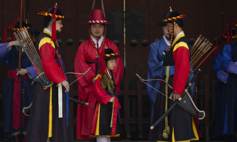 Guards wearing traditional uniforms take part in the royal guard-changing ceremony at Deoksugung Palace in Seoul, South Korea, April 14, 2024. The Royal Guard Changing Ceremony is a popular spectacle for tourists visiting Seoul. (Photo by Jun Hyosang/Xinhua)