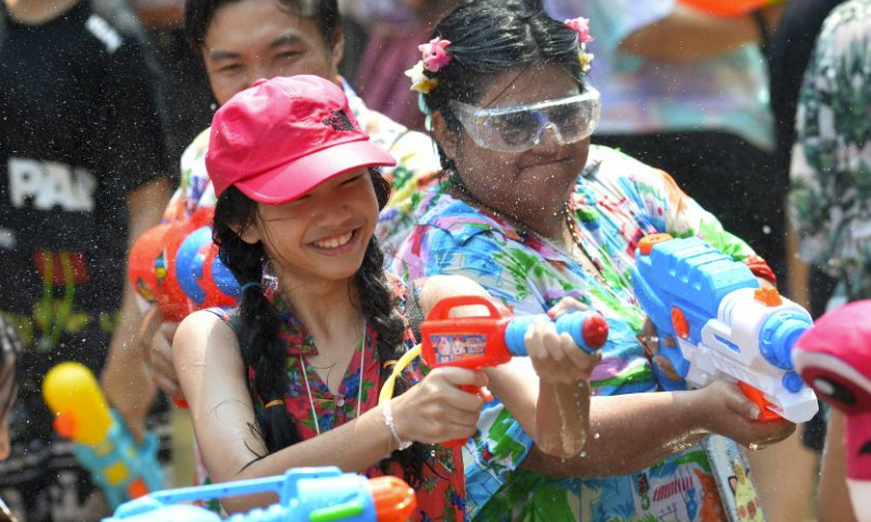 People splash water on one another in celebration of the Songkran festival in Bangkok, Thailand, April 13, 2024. The Songkran festival, the traditional Thai New Year, is celebrated from April 13 to 15 every year, during which people express greetings by splashing water on each other. 