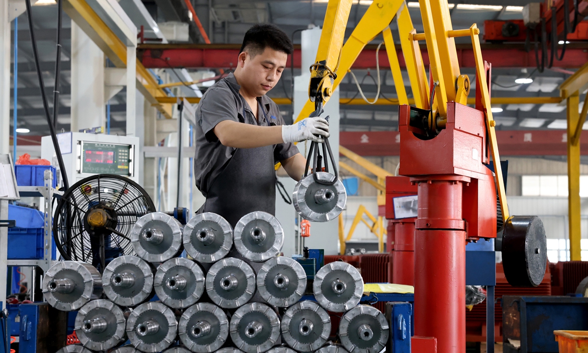 A worker arranges products inside an electric motor plant in Ningde, East China's Fujian Province on April 16, 2024. In the first quarter, China's exports of mechanical and electrical products increased 6.8 percent year-on-year to hit 3.39 trillion yuan ($470 billion), accounting for 59.2 percent of the total export value, according to customs data. Photo: VCG
